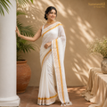Model wearing a classic white Kerala kasavu saree with gold zari border