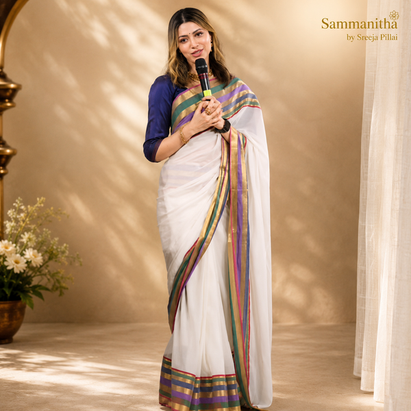 Model wearing a white saree with multicolour teal, purple, gold and red striped border and navy blue blouse